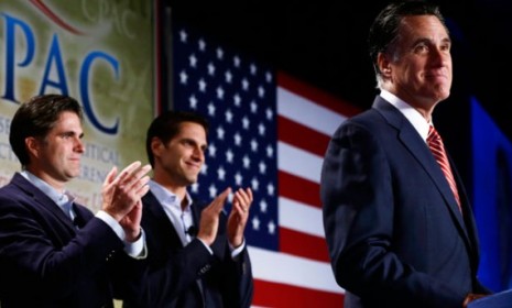 Mitt Romney is applauded by sons Josh (center) and Tagg (left) on Oct. 4