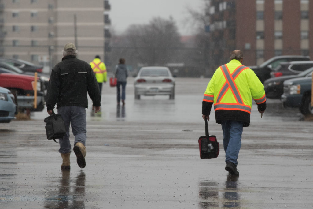 Workers leave the Oshawa General Motors.
