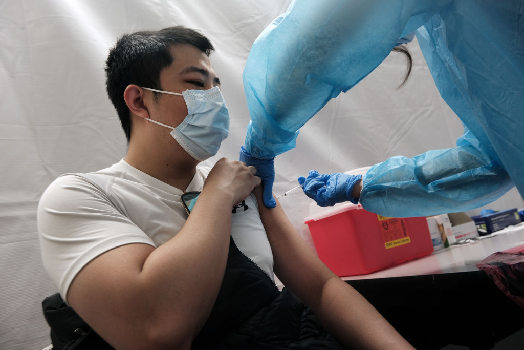 A man gets the Pfizer vaccine at a pop-up vaccination clinic in Chinatown on March 26, 2021 in New York City.