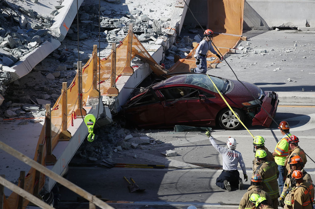 A car underneath a bridge that collapsed Thursday in Miami.