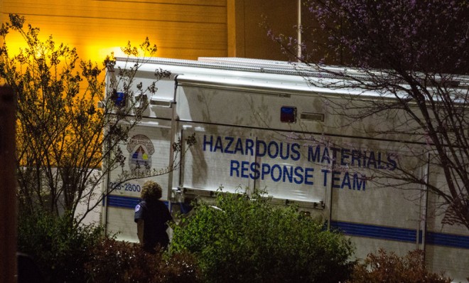 An official walks past a hazardous materials response team truck outside a mail sorting facility on April 16 in Hyattsville, Md.