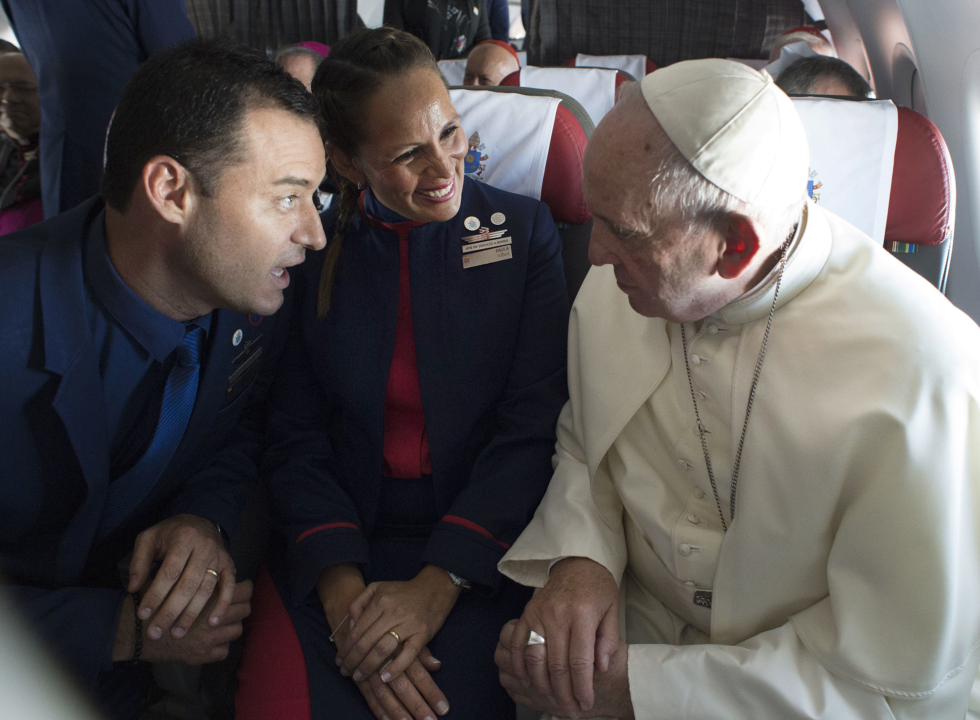 Pope Francis with flight attendants Carlos Ciuffardi and Paola Podest.