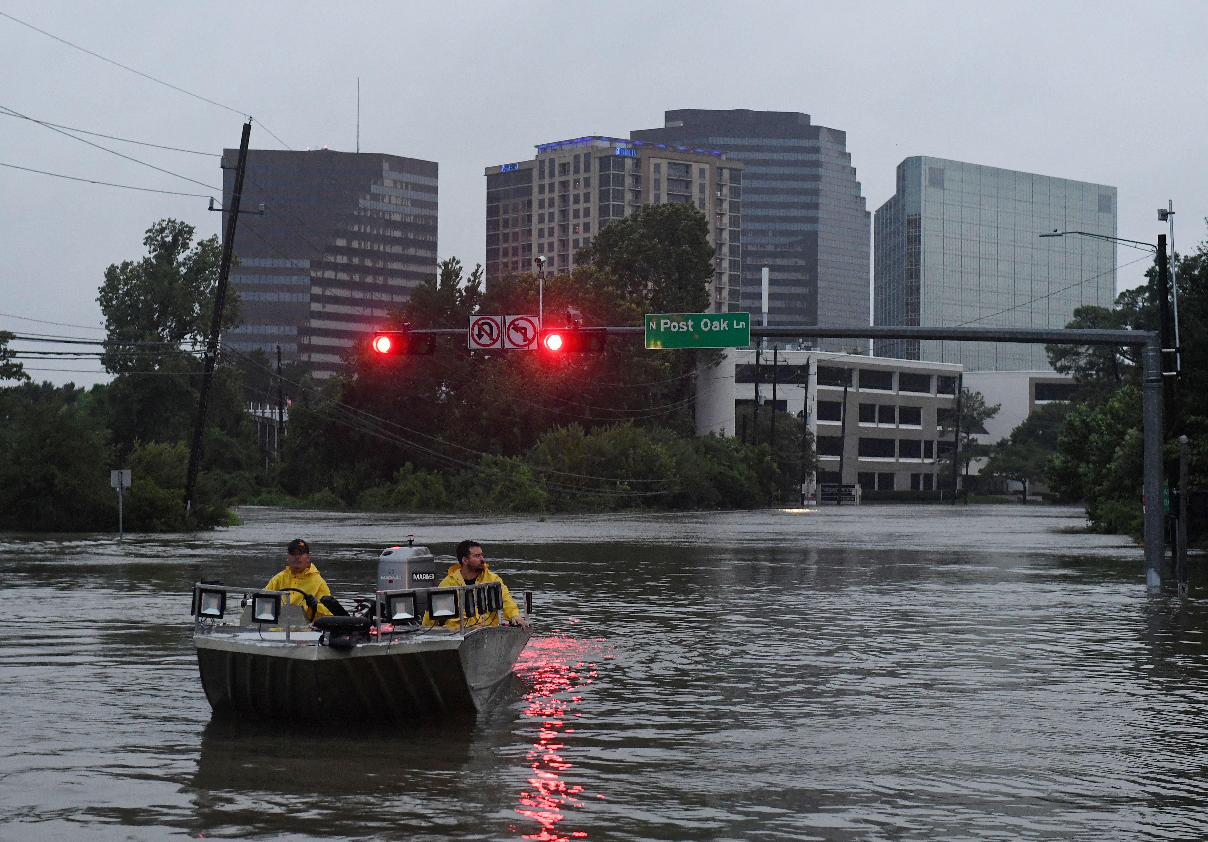 Rescue boat drives over a road in Houston