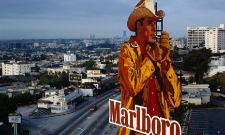 A Marlboro billboard over Los Angeles in 1990: Big tobacco companies are now looking into less-harmful smoking alternatives to help boost their bottom lines.