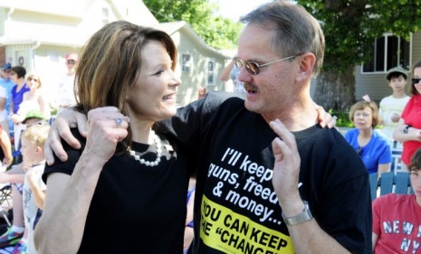 Rep. Michele Bachmann (R-Minn.) greets a supporter during a July 4 parade: The GOP presidential hopeful has signed a controversial anti-porn, anti-Sharia pledge.