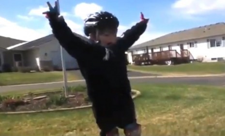This novice bike rider closes his rock star speech with a Richard Nixon-esque peace sign.