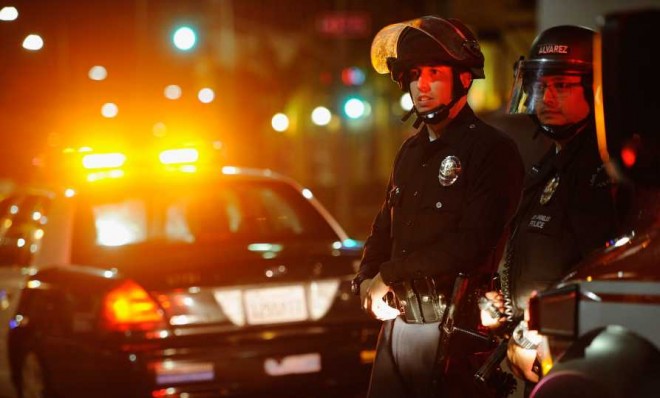 LAPD officers in riot gear look at protesters in the streets around Leimert Park following a prayer vigil against the acquittal of George Zimmerman on July 16.