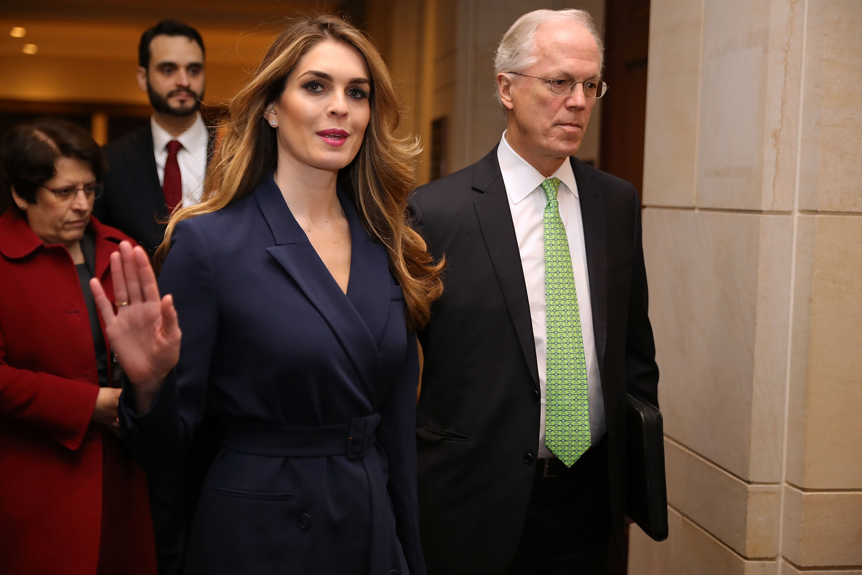 Hope Hicks waves at reporters