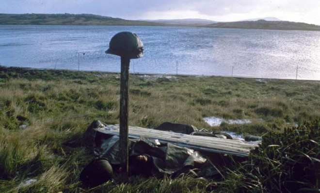 Steel helmets mark a makeshift grave for Argentines killed in the Falklands War.