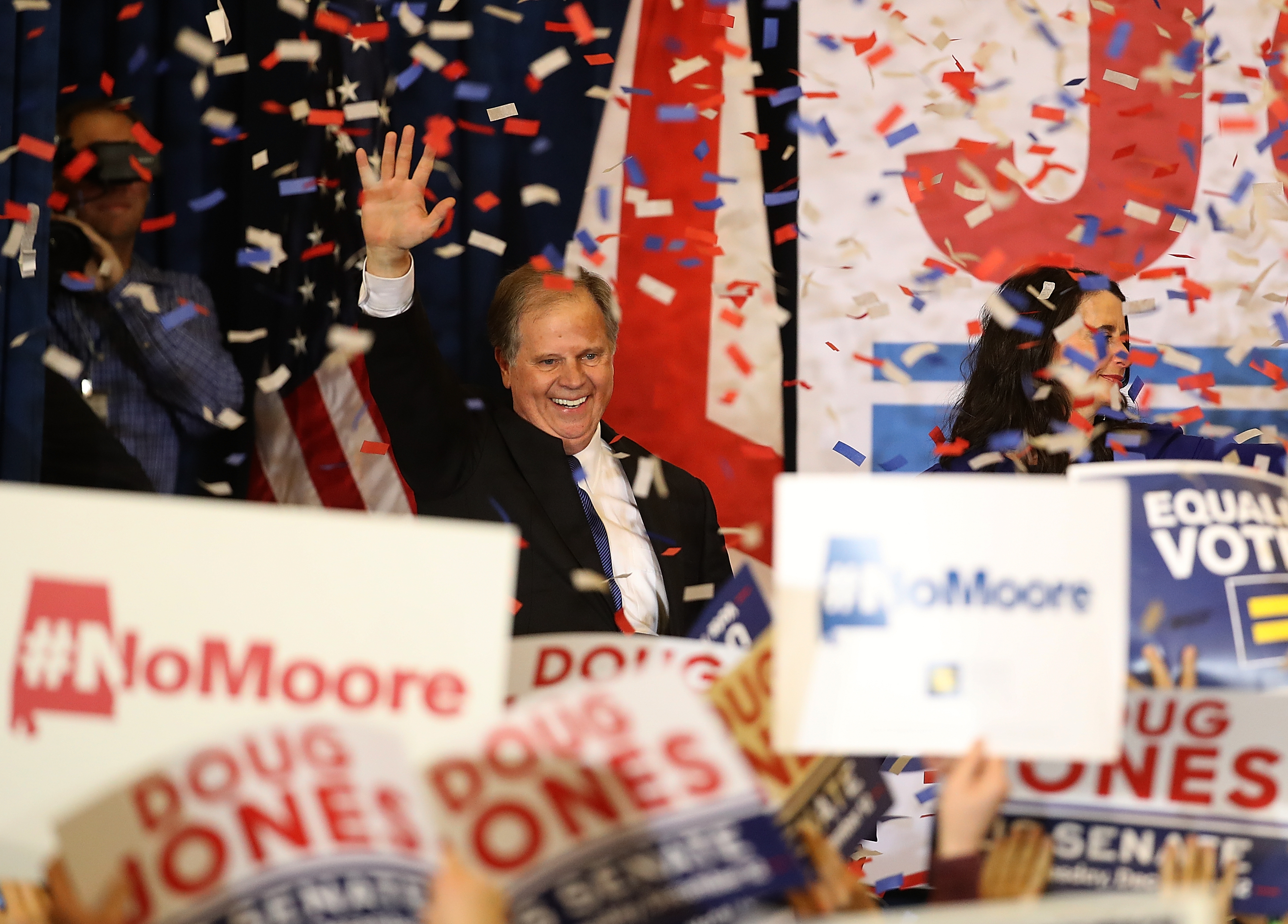 Doug Jones waves to a crowd of supporters