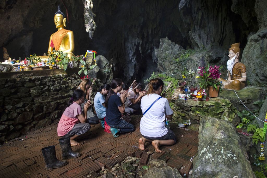 Family members pray outside Thai cave.