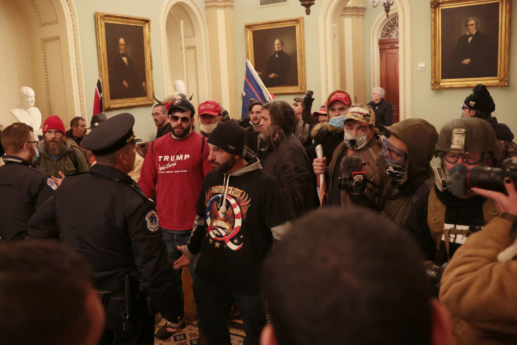 Protesters interact with Capitol Police inside the U.S. Capitol.