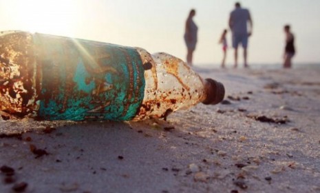 An oil-splattered water bottle on Pensacola Beach.
