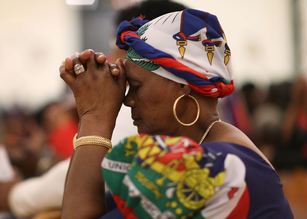 A Haitian woman prays.
