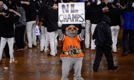 Mascot Lou Seal holds up a sign reading &#039;NL Champs&#039; after the Giants defeat the St. Louis Cardinals 9-0 to advance to the World Series. 