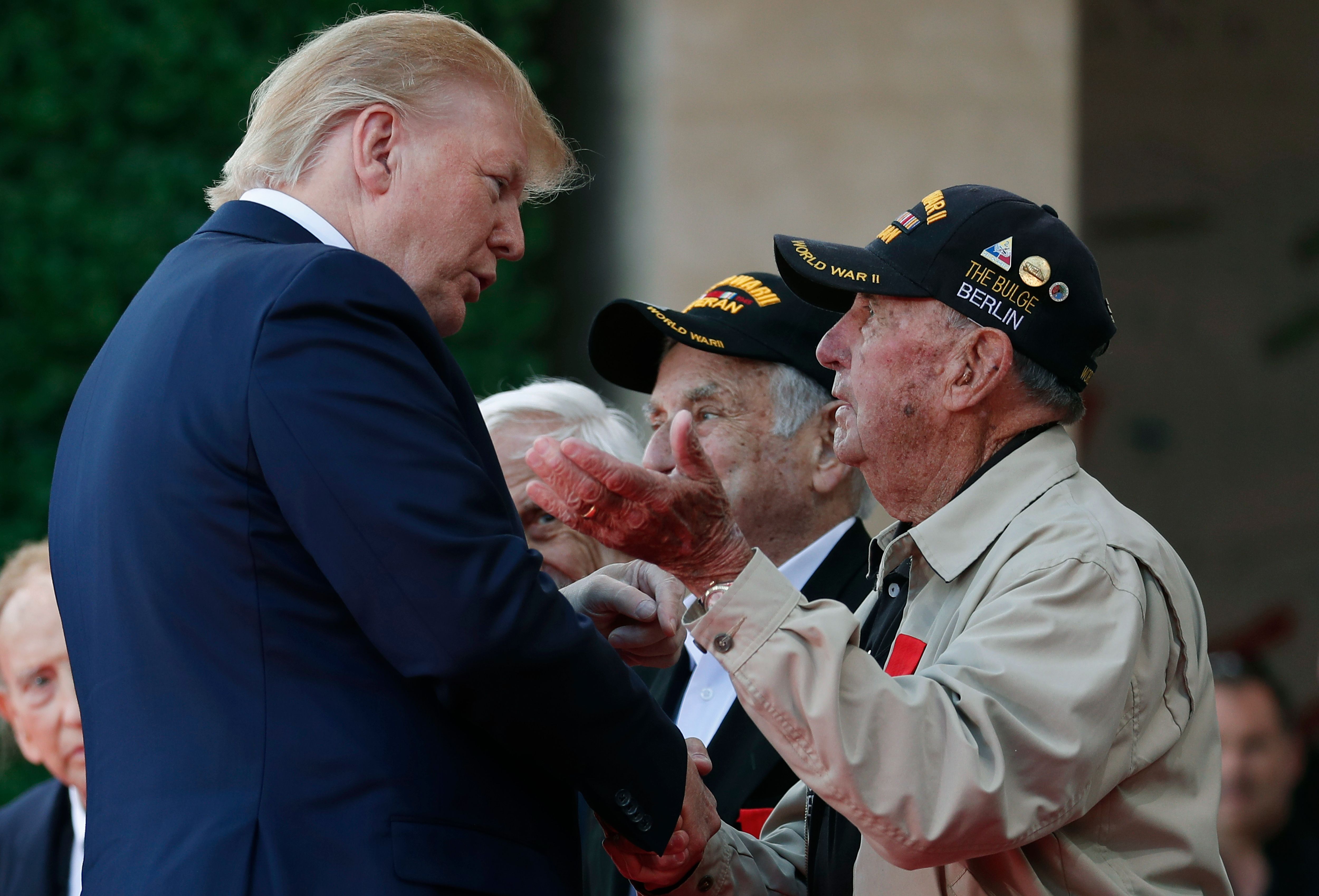 Trump greets a veteran at a D-Day commemoration ceremony