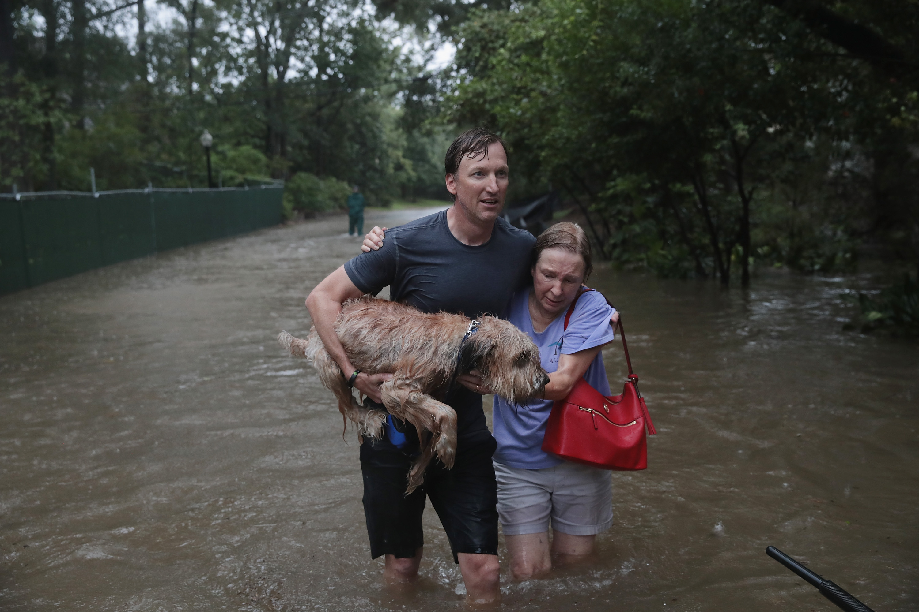 Couple and their dog flee flooding in Houston