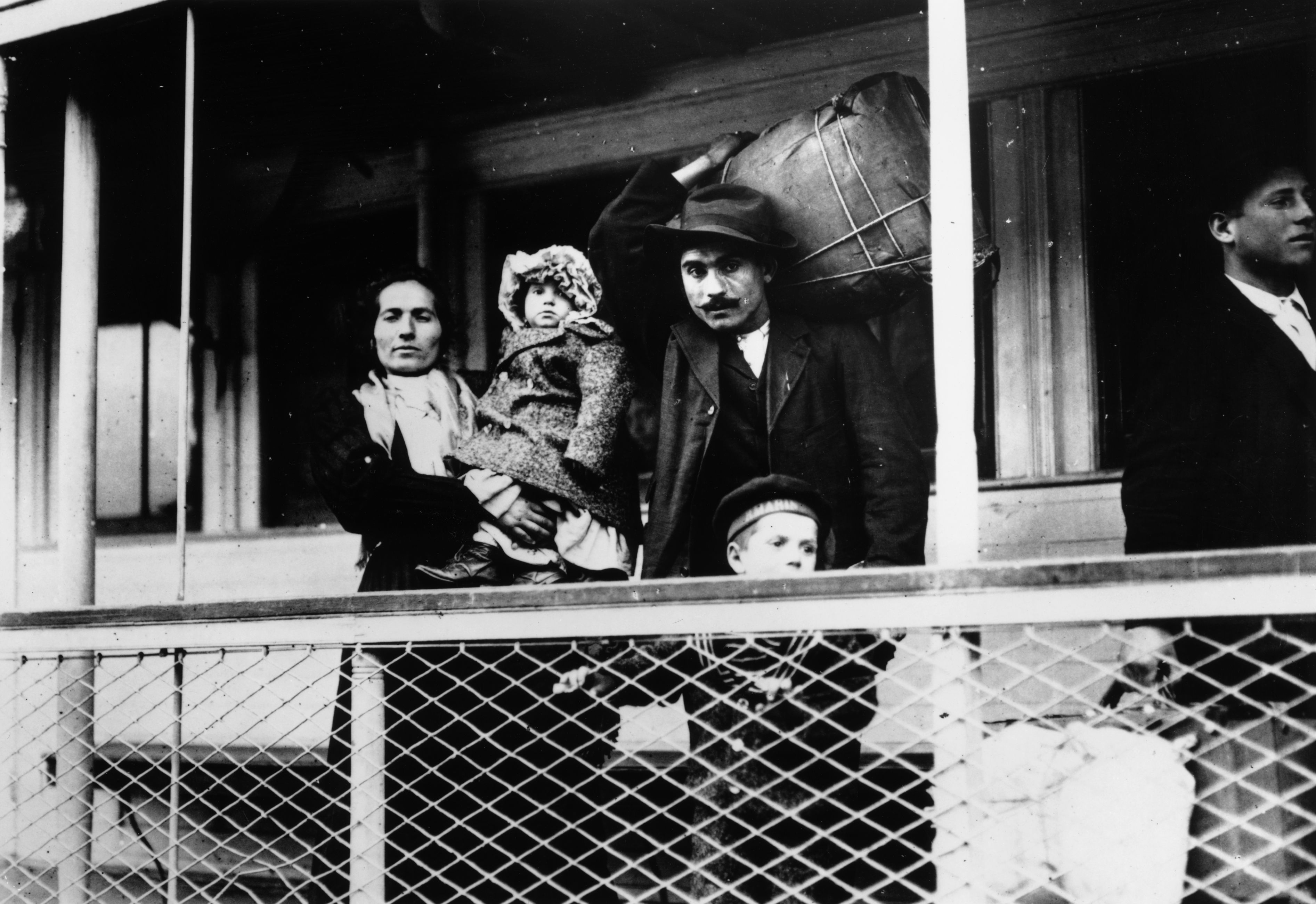 An Italian family prepares to pass through Ellis Island, 1905.