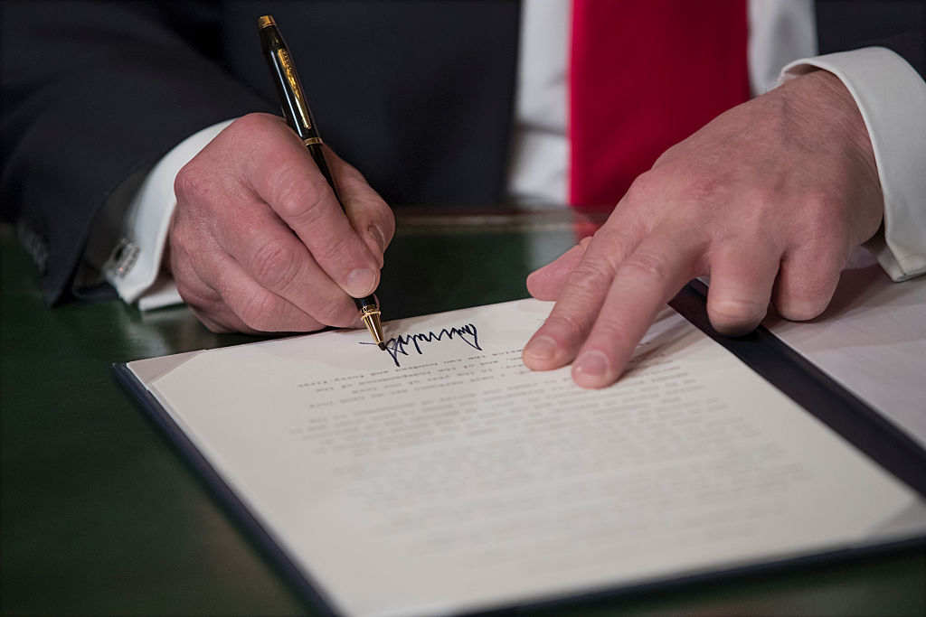 President Trump signs.