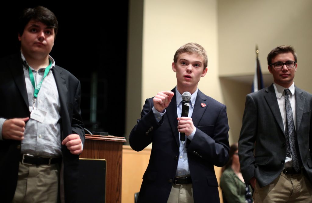 Tyler Ruzich (C), 17, of Prairie Village, Kansas, flanked by Jack Bergeson, 16, of Wichita and Dominic Scavuzzo, 17, of Leawood speaks during a forum with the three other teenage candidates f