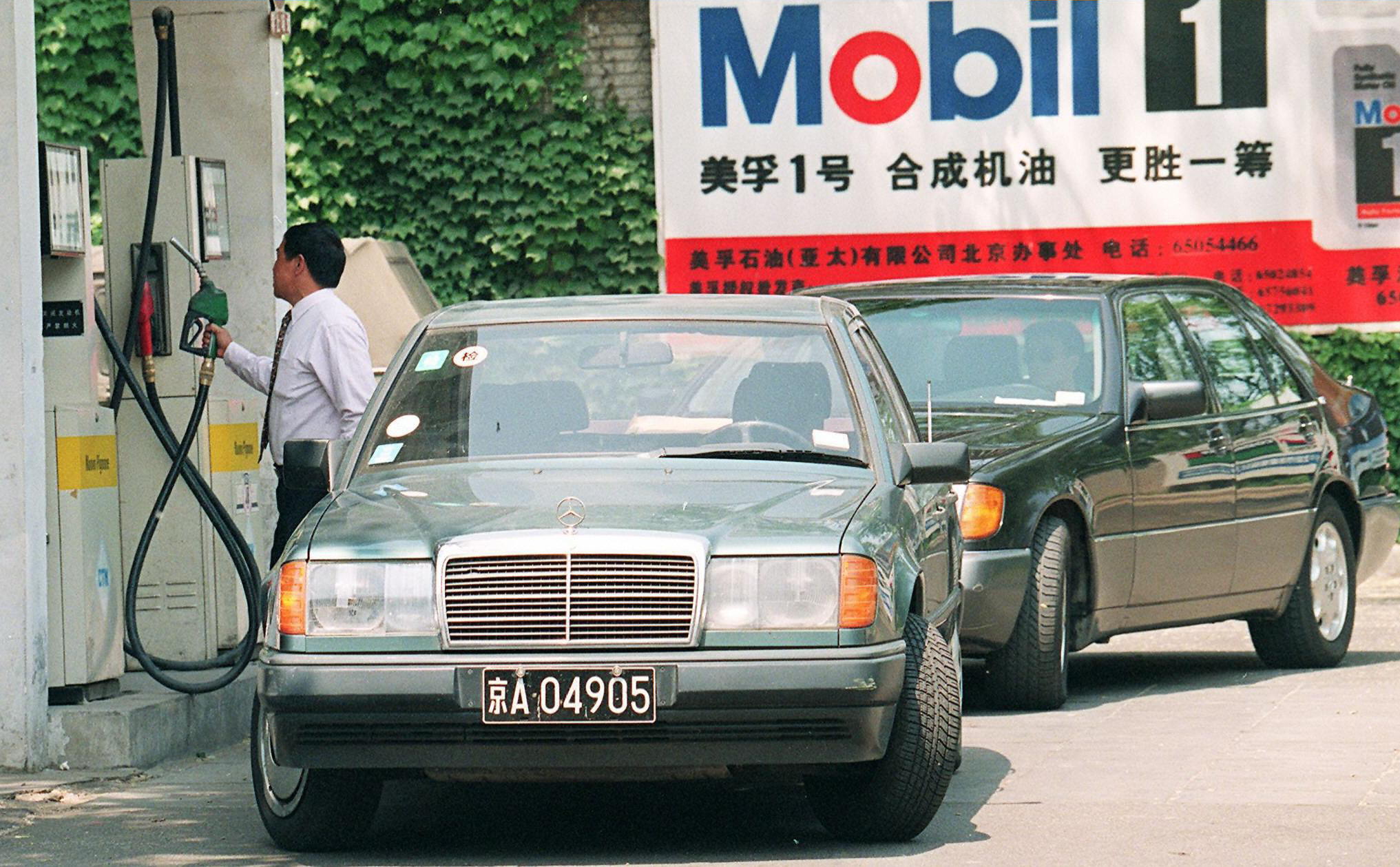 Customers fill up their gas tanks in China