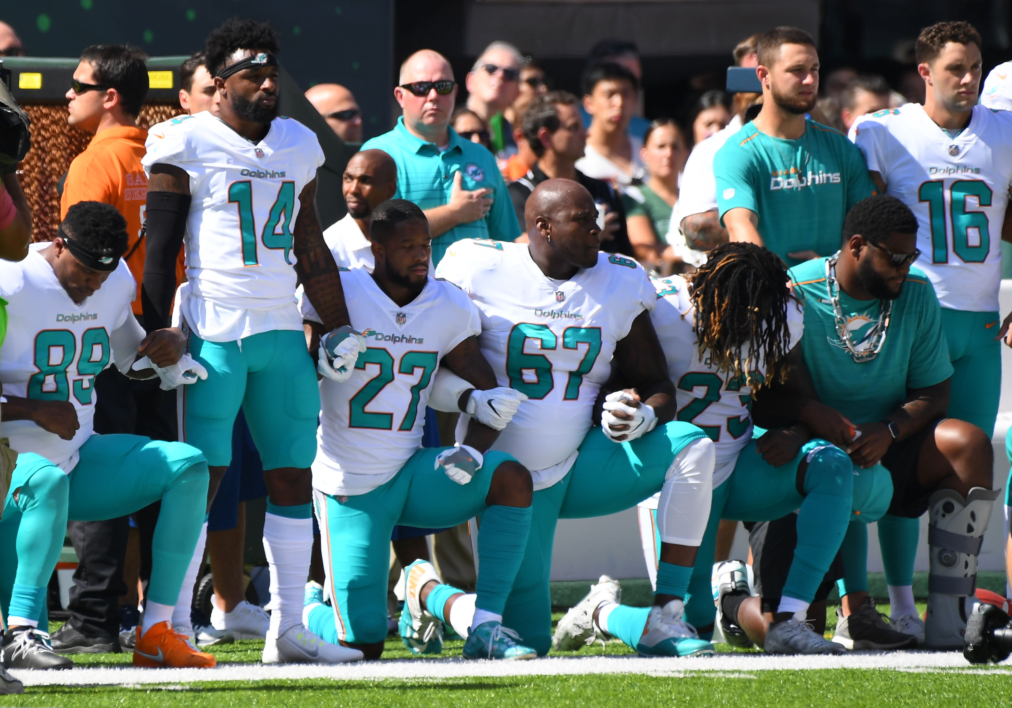 Miami Dolphins players take a knee