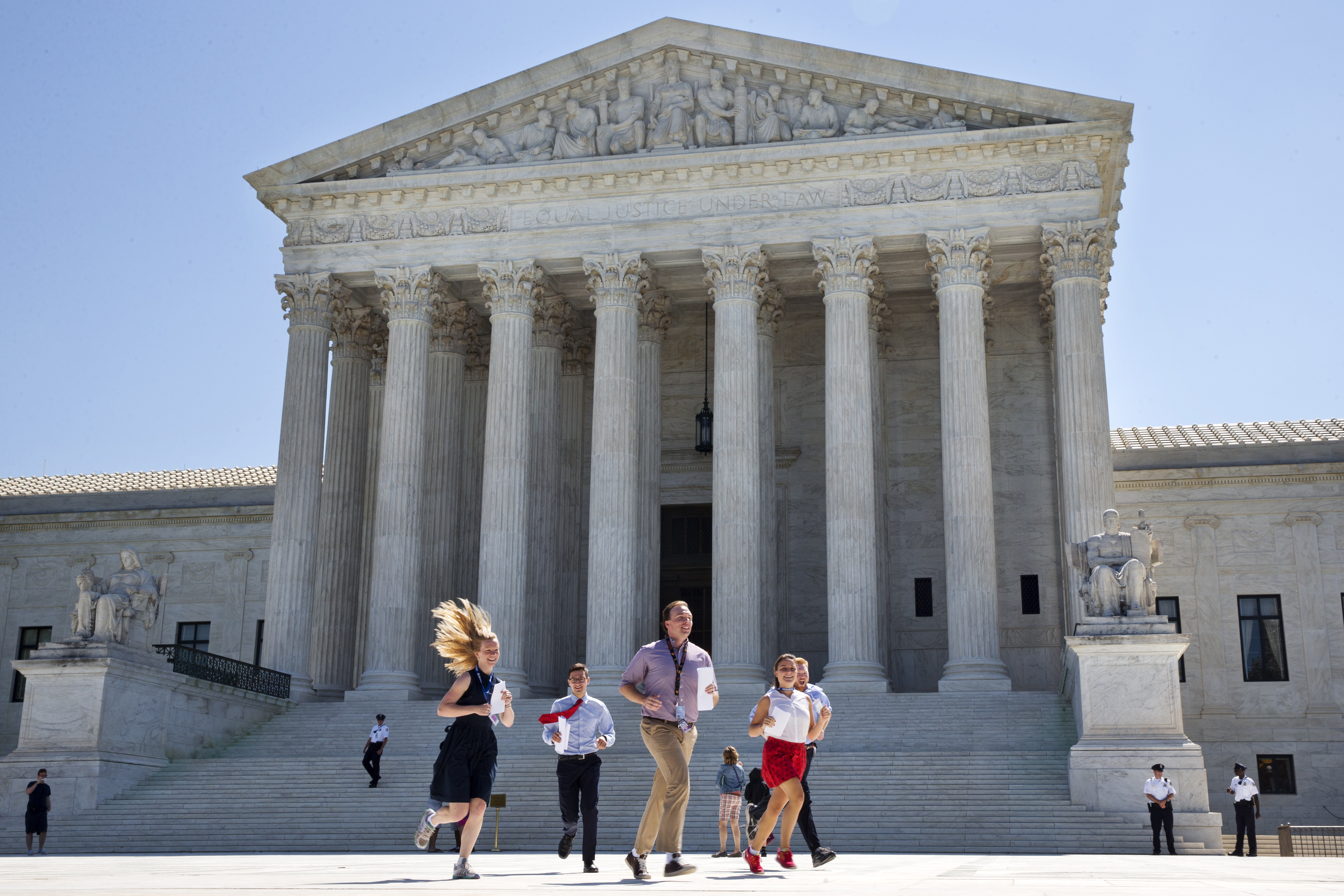 Interns run to deliver a Supreme Court decisions.