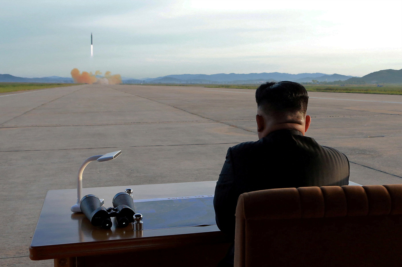 North Korean leader Kim Jong-Un watches a missile test.