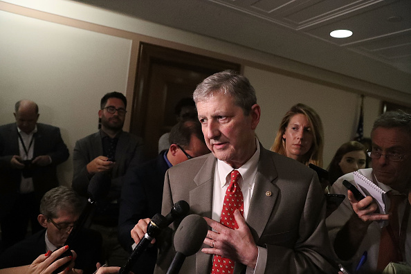 Sen. John Kennedy talks to reporters about health care in July.