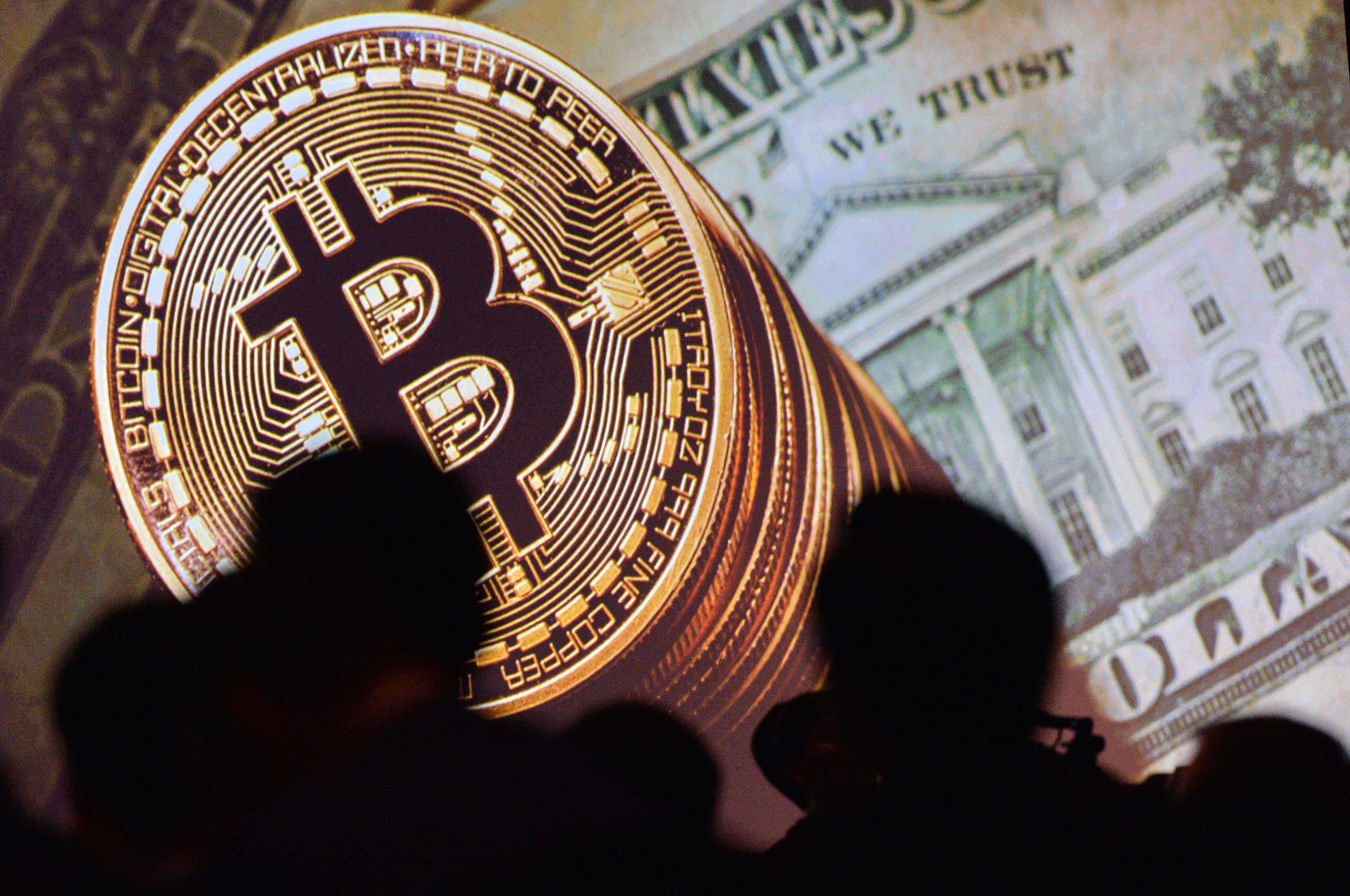 Bitcoin is seen next to the dollar