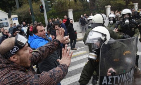 Greek anti-austerity protesters confront riot police Friday