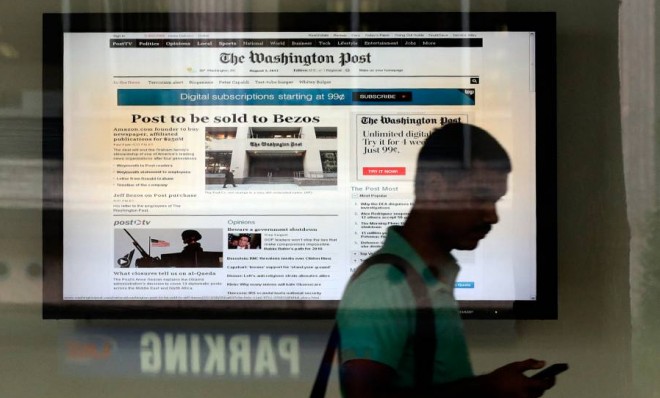 A man leaves the Washington Post building after the announced sale of the newspaper on August 5.
