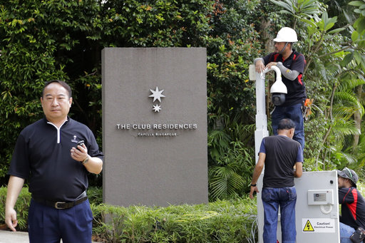 Technicians install a surveillance camera at the entrance of Capella Hotel on Sentosa island on Saturday, June 9, 2018, in Singapore ahead of the summit between U.S. President Donald Trump an