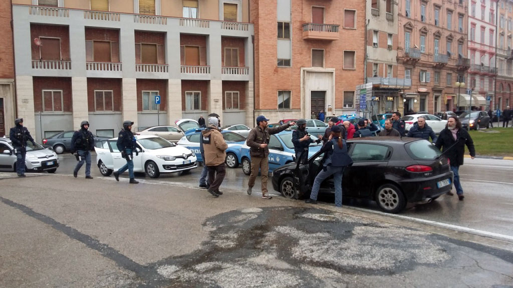 The black car Alfa Romeo of young man suspected of wounding several foreign nationals in a drive-by shooting,is blocked by police and Carabibieri enforcement at Macerata, on 3 February 2018