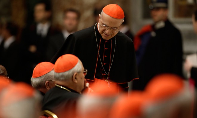 Vatican chamberlain Cardinal Tarcisio Bertone (standing) has the daunting job of keeping the conclave leak-proof.