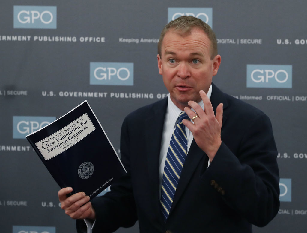 Mick Mulvaney holds up a copy of Trump&#039;s fiscal 2018 blueprint