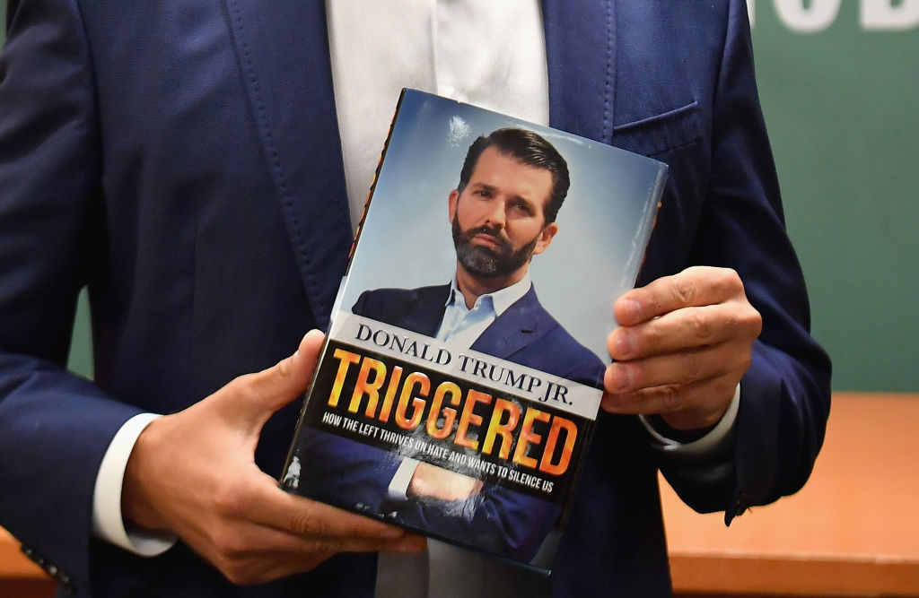 Donald Trump Jr. holds a copy of his new book.