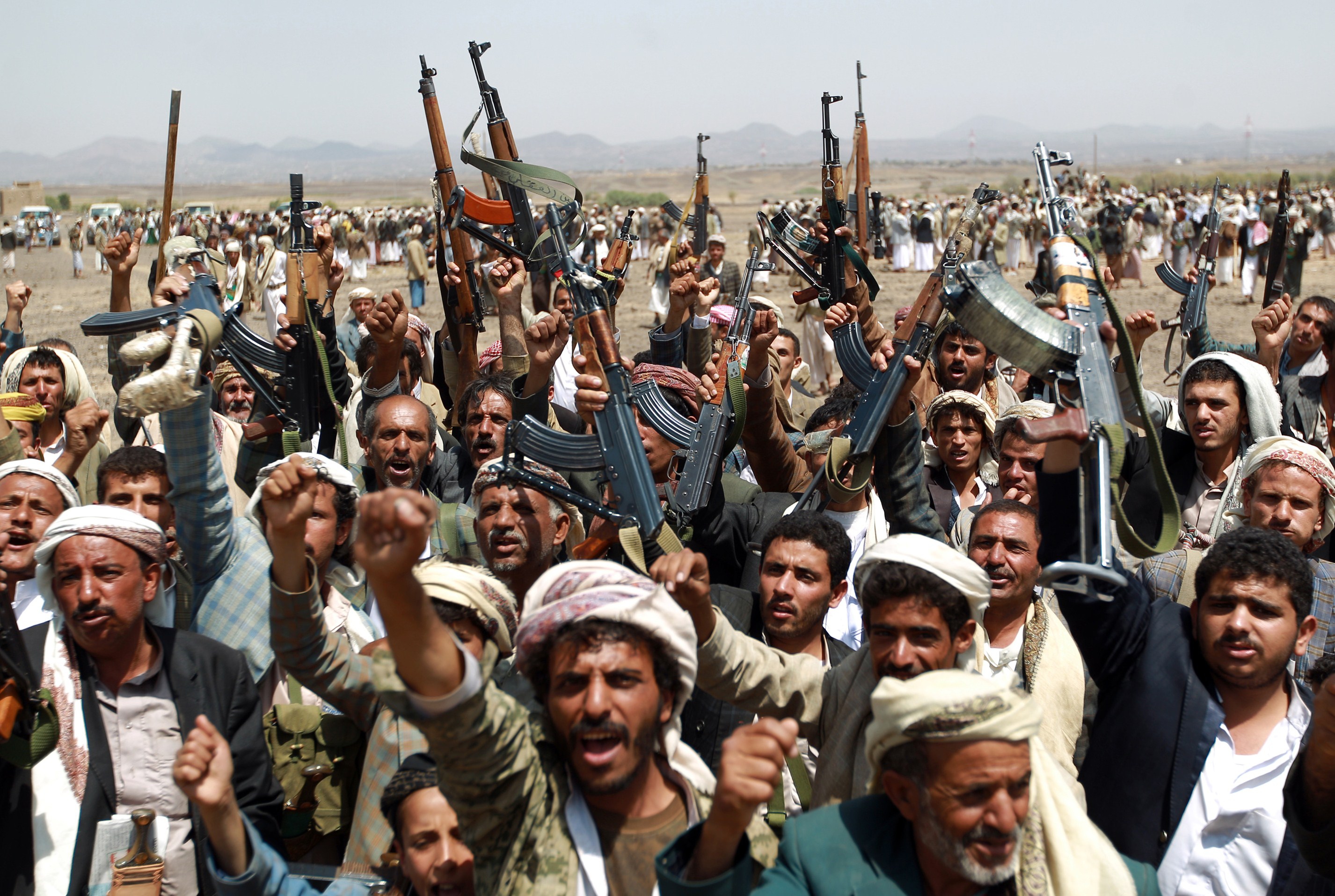 A group of Yemeni men loyal to the Houthi movement chant slogans.