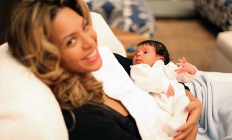 Beyonce holds her newborn Blue Ivy Carter