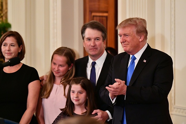 Brett Kavanaugh stands with his daughters, wife, and the president.