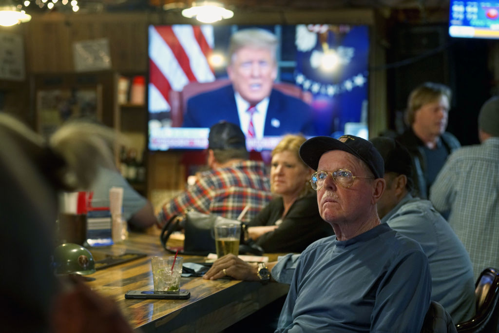 Legion club members watch President Trumps Oval Office speech.