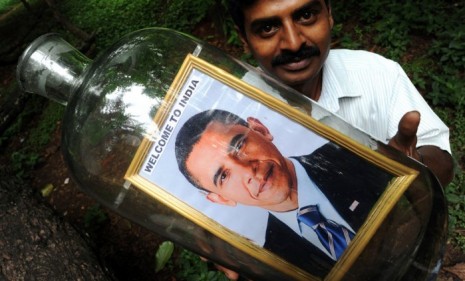 A Bangalore artist holds one of his Obama-in-a-bottle creations as India prepares for the President&#039;s four-day visit.