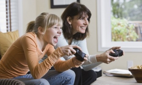 A study finds that girls who play video games with their parents feel more connected to their families than boys would in the same situation.