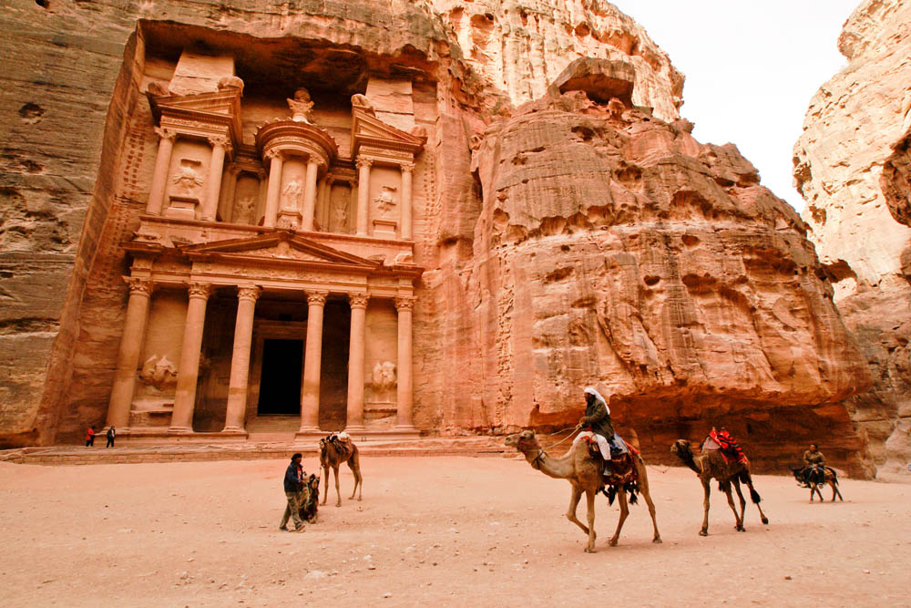 Petra&#039;s Treasury, carved from sandstone cliffs.