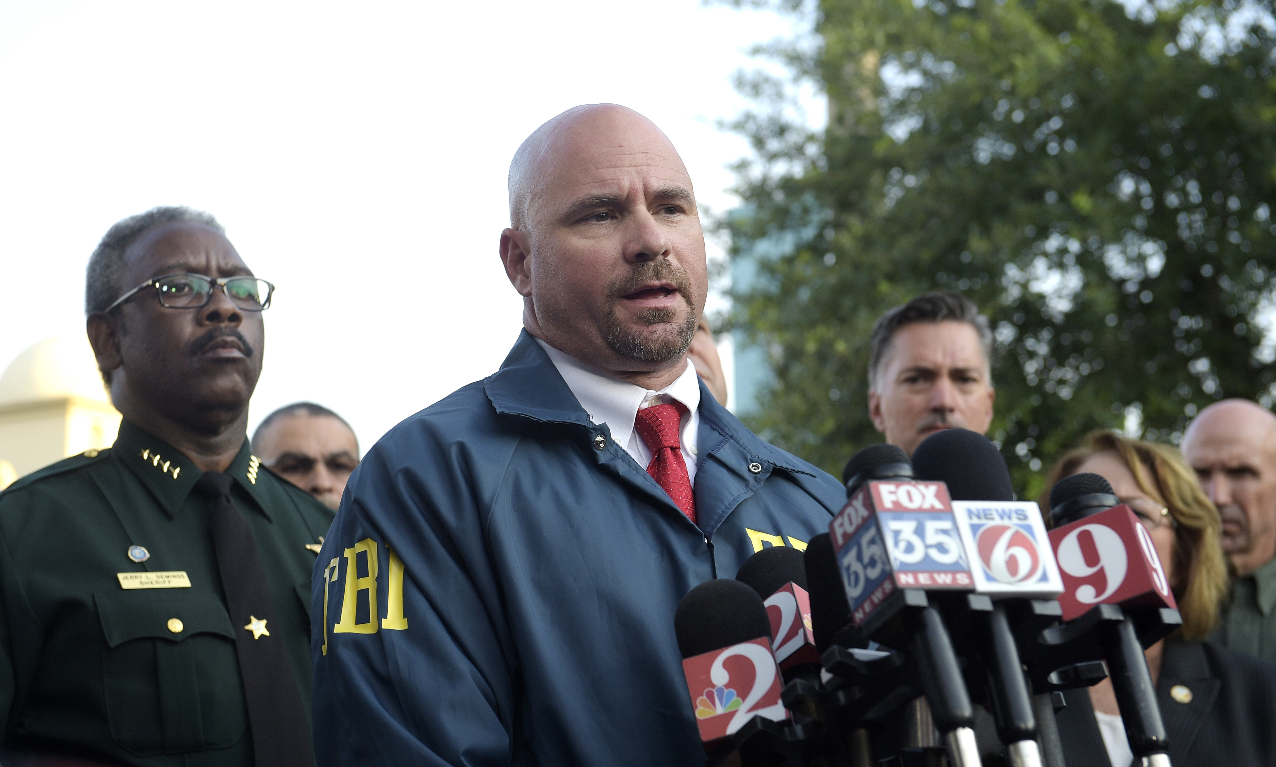 FBI agent Ron Hopper speaks with reporters