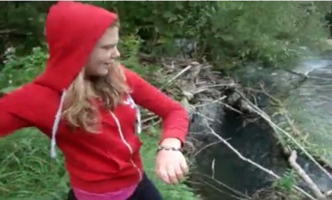 The girl who filmed herself throwing puppies into a river has been identified. 
