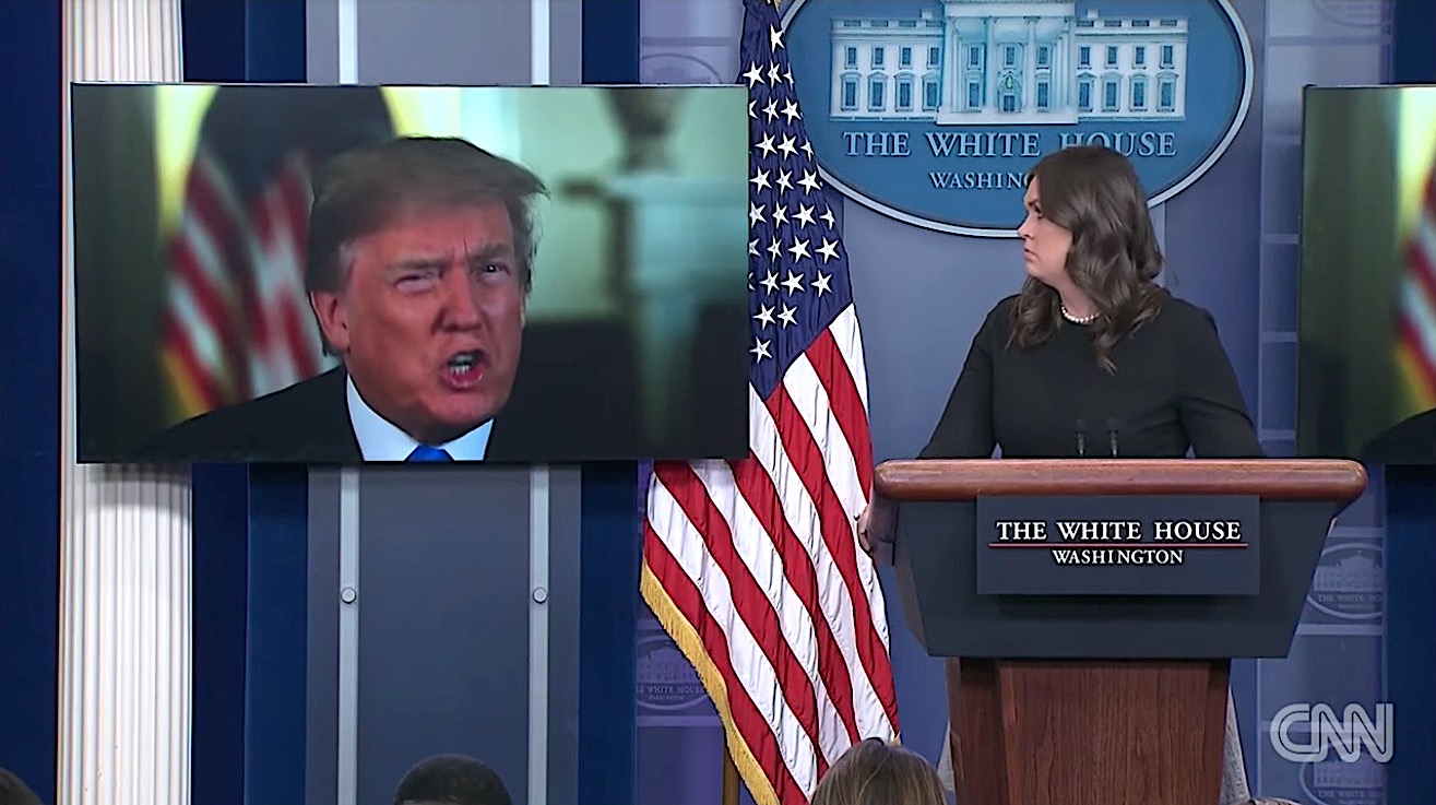 Sarah Huckabee Sanders stares at President Trump