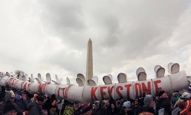 During a protest opposing the Keystone XL pipeline, demonstrators carry a replica of the pipeline in Washington, Feb. 17.
