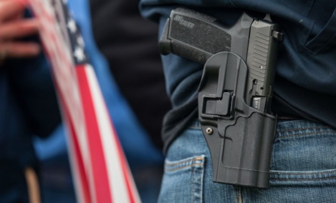 A pro-gun demonstrator carries a handgun at a rally in Olympia, Washington, Jan. 19.