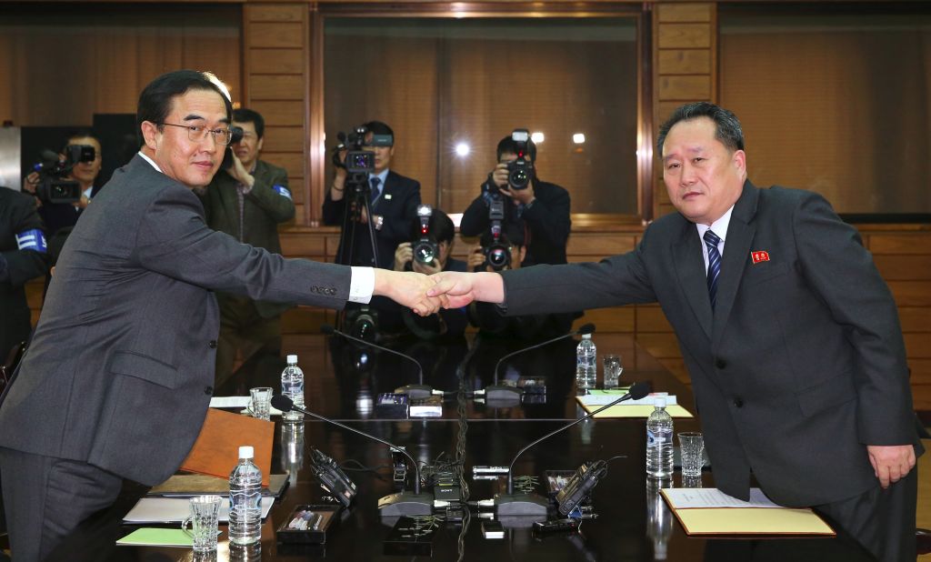 Korean unification officials shake hands after preparatory summit